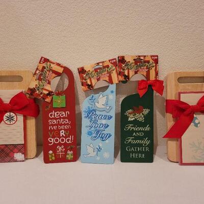Lot 76: Set of (2) New Hallmark Christmas Cutting Blocks and (3) New Christmas Spirit Door Hangers