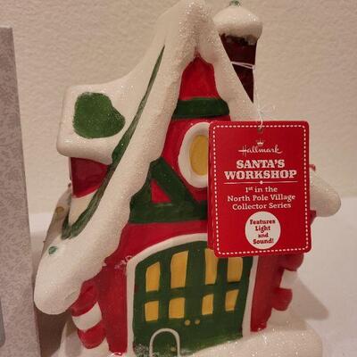 Lot 87: New Precious Moments LED Musical Tabletop Angel + New HALLMARK Santa's Workshop (needs batteries)