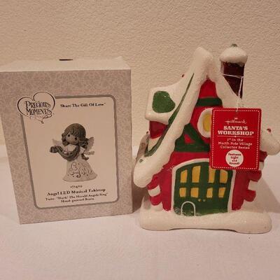 Lot 87: New Precious Moments LED Musical Tabletop Angel + New HALLMARK Santa's Workshop (needs batteries)