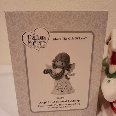 Lot 87: New Precious Moments LED Musical Tabletop Angel + New HALLMARK Santa's Workshop (needs batteries)