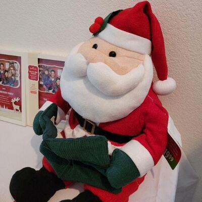 Lot 102: NEW Santa Hats (3), Santa Animated Plushie, and (2) Picture Frames