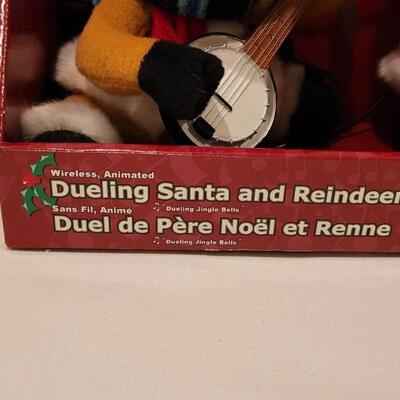 Lot 105: New Animated Dueling Santa & Reindeer 