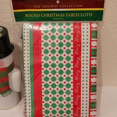 Lot 138: NEW Christmas Cheer Kitchen Lot- 6 Packages of Disposable Napkins,  Disposable Plates, Tablecloth & Snowman Tins