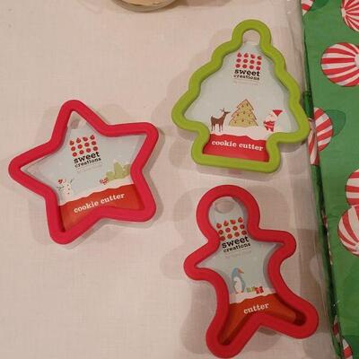 Lot 152: NEW Cookie Cutters, Tablecloth, Bowl & Plates with Spreaders, Snowman Tin and Holiday Candle