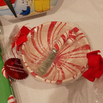 Lot 152: NEW Cookie Cutters, Tablecloth, Bowl & Plates with Spreaders, Snowman Tin and Holiday Candle