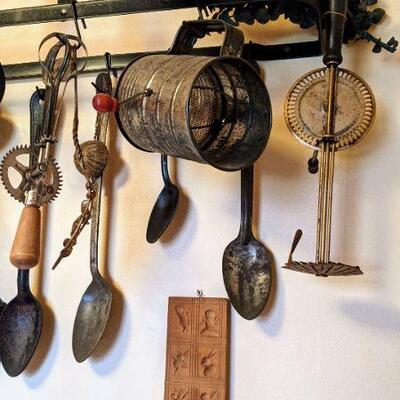 Primitive kitchen tools with wall rack Spoons whisks sifter etc