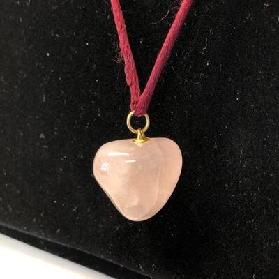 Lot 81 - Polished Pink Heart Shaped Stone on Silk Rope