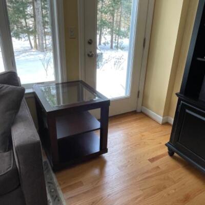 Two glass and wood side tables 