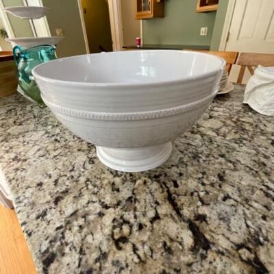 Large white bowl with pedestal and serving spoons
