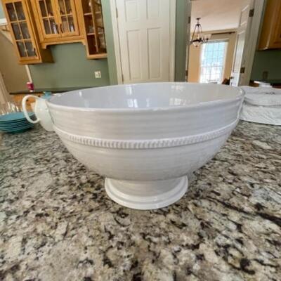 Large white bowl with pedestal and serving spoons