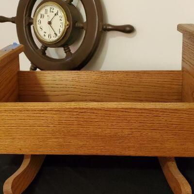 Lot 5:  Wooden handcrafted doll cradle and a ships wheel clock