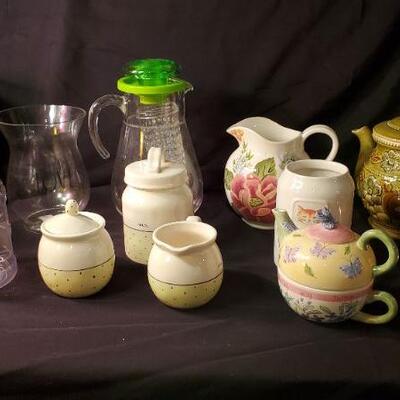 Lot 41: Ceramic tea pots, copper tea kettle, snack set, pitcher, Jack Daniels tin, and more.