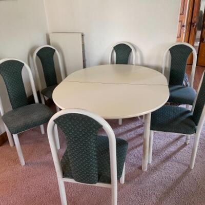  Lot 1. Formica dining table, white top, with 6 upholstered chairs; oval-shaped, 50â€x42â€,with one leaf--$45