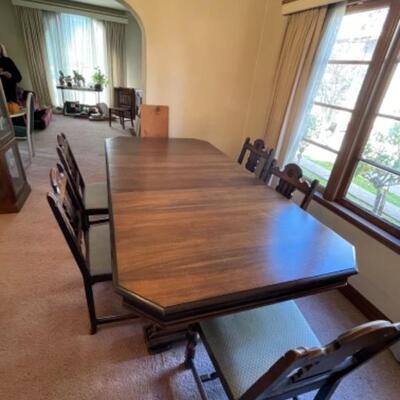 Lot 5. 1940s walnut dining table with two leaves, 64â€x47â€, 6 chairs and two 10-inch leaves--$95