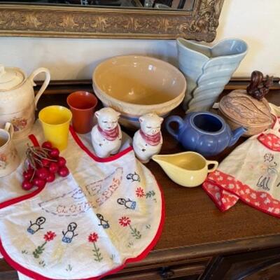 Lot 9. Assorted vintage pottery, wooden fruit, and aprons--$95
