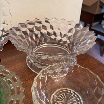 Lot 14. Assorted glassware, Fostoria American, green depression glass, covered cake plate, compotes, candy dish, etc.--$75