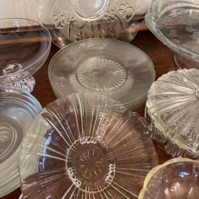 Lot 14. Assorted glassware, Fostoria American, green depression glass, covered cake plate, compotes, candy dish, etc.--$75