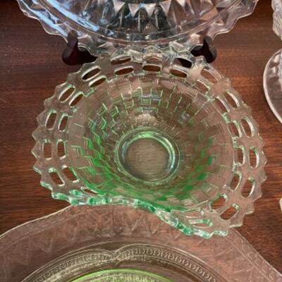 Lot 14. Assorted glassware, Fostoria American, green depression glass, covered cake plate, compotes, candy dish, etc.--$75