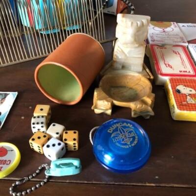 Lot 32. Vintage mid-century games/vintage decks of cars; 45 RPM record rack, dice, vintage childrenâ€™s game and badges, and marble Aztec...