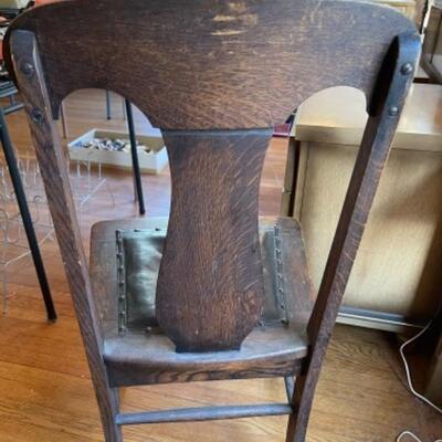Lot 57. Oak chair with leather seat and claw feet (1920s)--$25