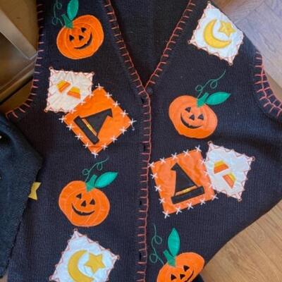 Lot 62. Four holiday vestsâ€”2 Halloween and 2 Christmas--$30
