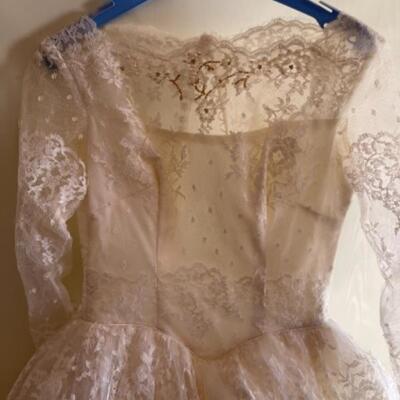 Lot 71. Vintage wedding dress, cake topper/stands, ephemera (invitations, program and favors--$125