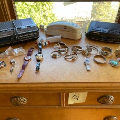 Lot 73. Ten watches, two alarm clocks, 1 phone, keychains, two purse holders and one Bulova watch/1960s with case--$65
