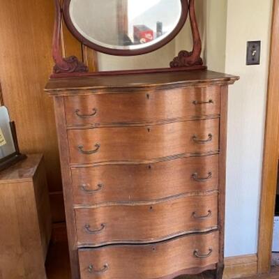 Lot 90. Vintage bow-front highboy, walnut, on wooden casters, 5 drawers, married to a swivel mahogany mirror, all original--$95