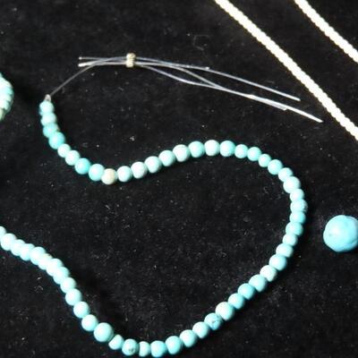 Turquoise beads, Ivory necklace, and silver necklace 
