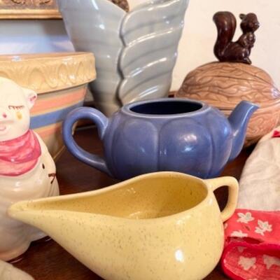 Lot 9. Assorted vintage pottery, Bauer Vase, wooden fruit, and aprons--$40