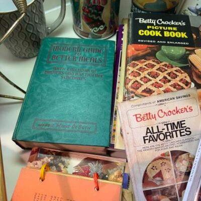 Lot 40. Kitchenwareâ€”cookbooks, chafing dishes (mid-century Bauer), commemorative tins, wine clips, mugs--$40