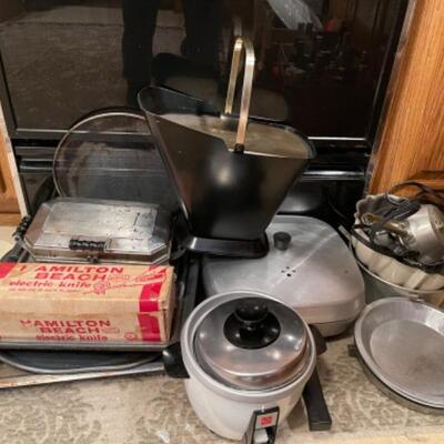 Lot 45. Mid-century West Bend ice bucket, cookware, vintage electric knife (Hamilton Beach), panini maker, baking sheets, bundt cake...