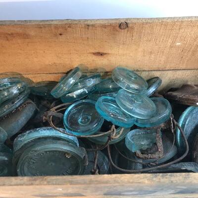 Lot 201:  Large lot Antique Glass Jar Lids/ Advertising Crate