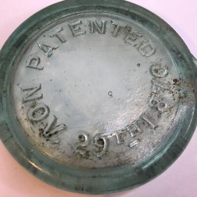 Lot 201:  Large lot Antique Glass Jar Lids/ Advertising Crate