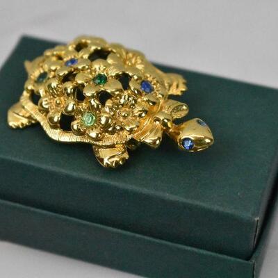 Turtle Lapel Pin by Avon. Gold tone with Blue & Green Stones