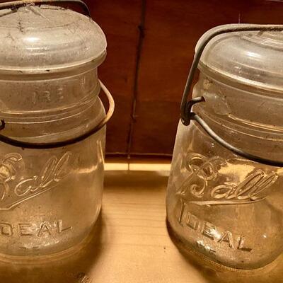 Lot 285: Box lot of 14 pint size Ball Ideal mason jars with wire bales and glass lids