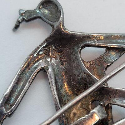 Lot JMO4: Large Silver and Marcasite Brooch of a person riding a penny farthing high bike. Articulated wheels. 