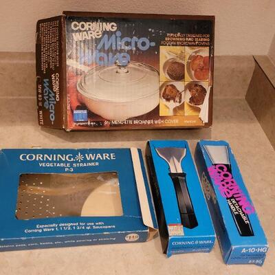 Lot 56: NEW OLD Stock Corning Ware (2) Handles, Microwave Dish and Veggie Strainer 