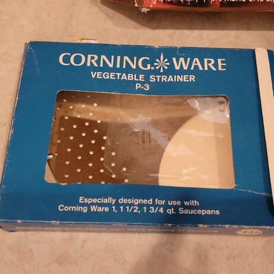 Lot 56: NEW OLD Stock Corning Ware (2) Handles, Microwave Dish and Veggie Strainer 