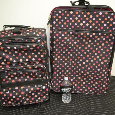 LOT 472 TWO POKA DOT ROLLING SUIT CASES 