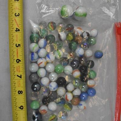 75+ Marbles. 2 Large, the rest are the regular smaller size