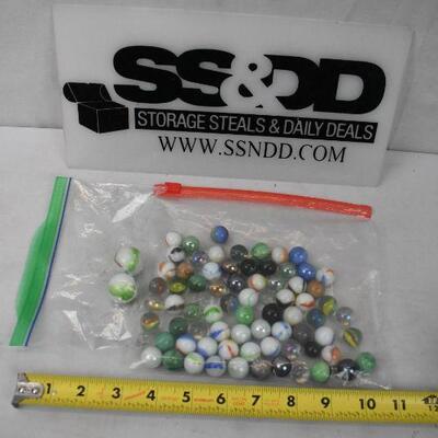 75+ Marbles. 2 Large, the rest are the regular smaller size