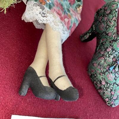 Lot 692 - Doll and decorative shoes