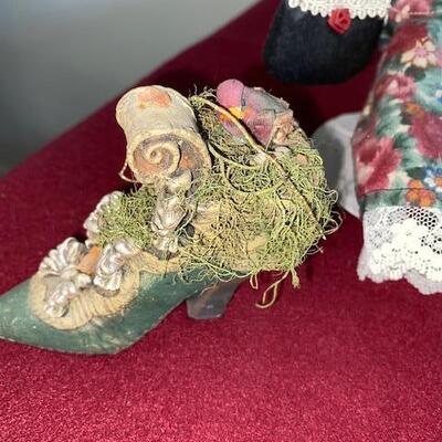 Lot 692 - Doll and decorative shoes