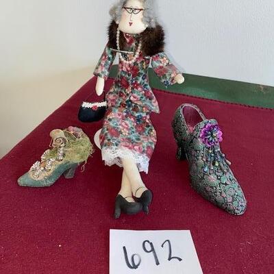 Lot 692 - Doll and decorative shoes