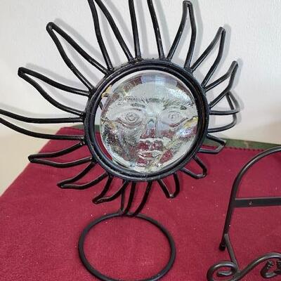 Lot 715 - metal plate racks and sun candle holder