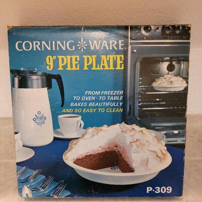 Lot 35: New Corning Ware Pie Plate and Handle in Boxes and (4) used Handles