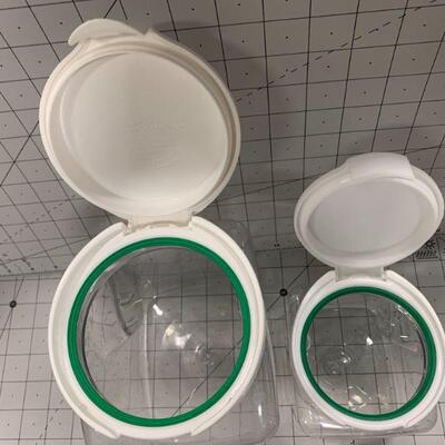 2 plastic containers with white lids