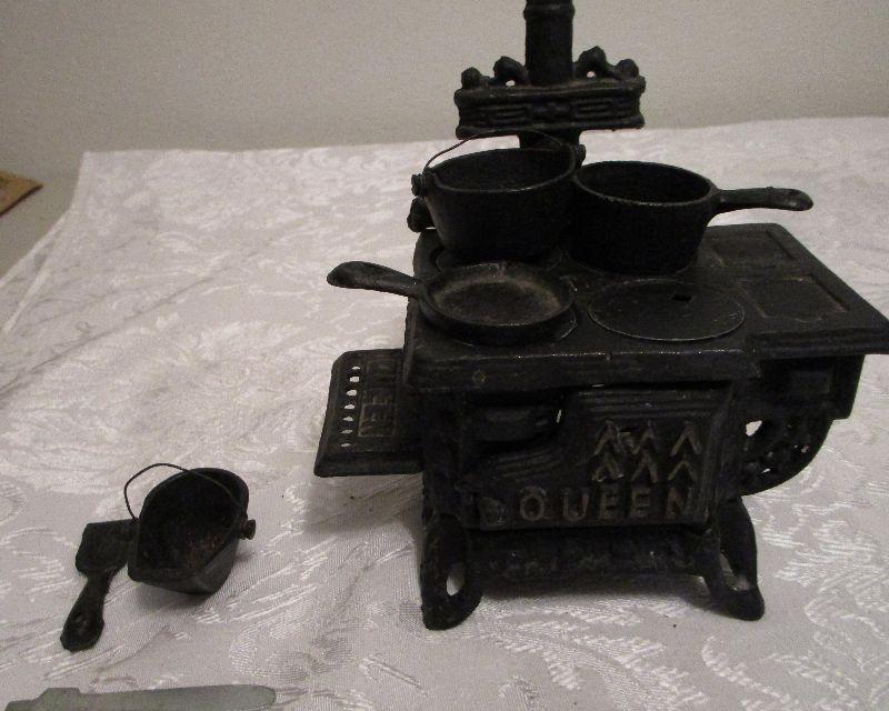 Sold at Auction: QUEEN MINIATURE CAST IRON STOVE W PANS