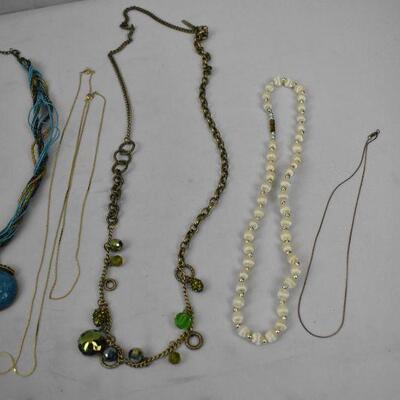 12 pc Jewelry: 2 bracelet, 10 necklaces (4 plain, 6 decorated)
